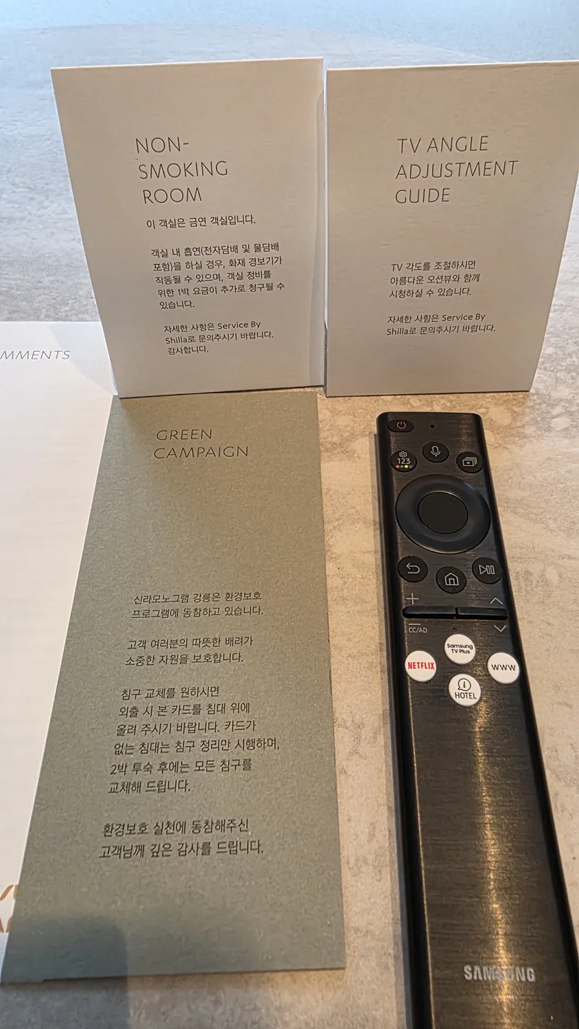 신라모노그램 강릉 객실 탁자 위 리모컨과 안내지